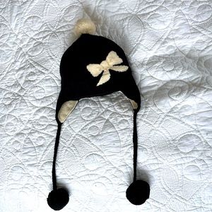 Cute Kate Spade black and cream knit hat with bow, pom poms and ear flaps